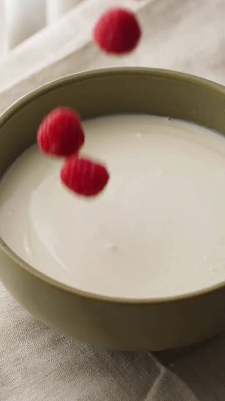 Raspberries Falling Into Cream