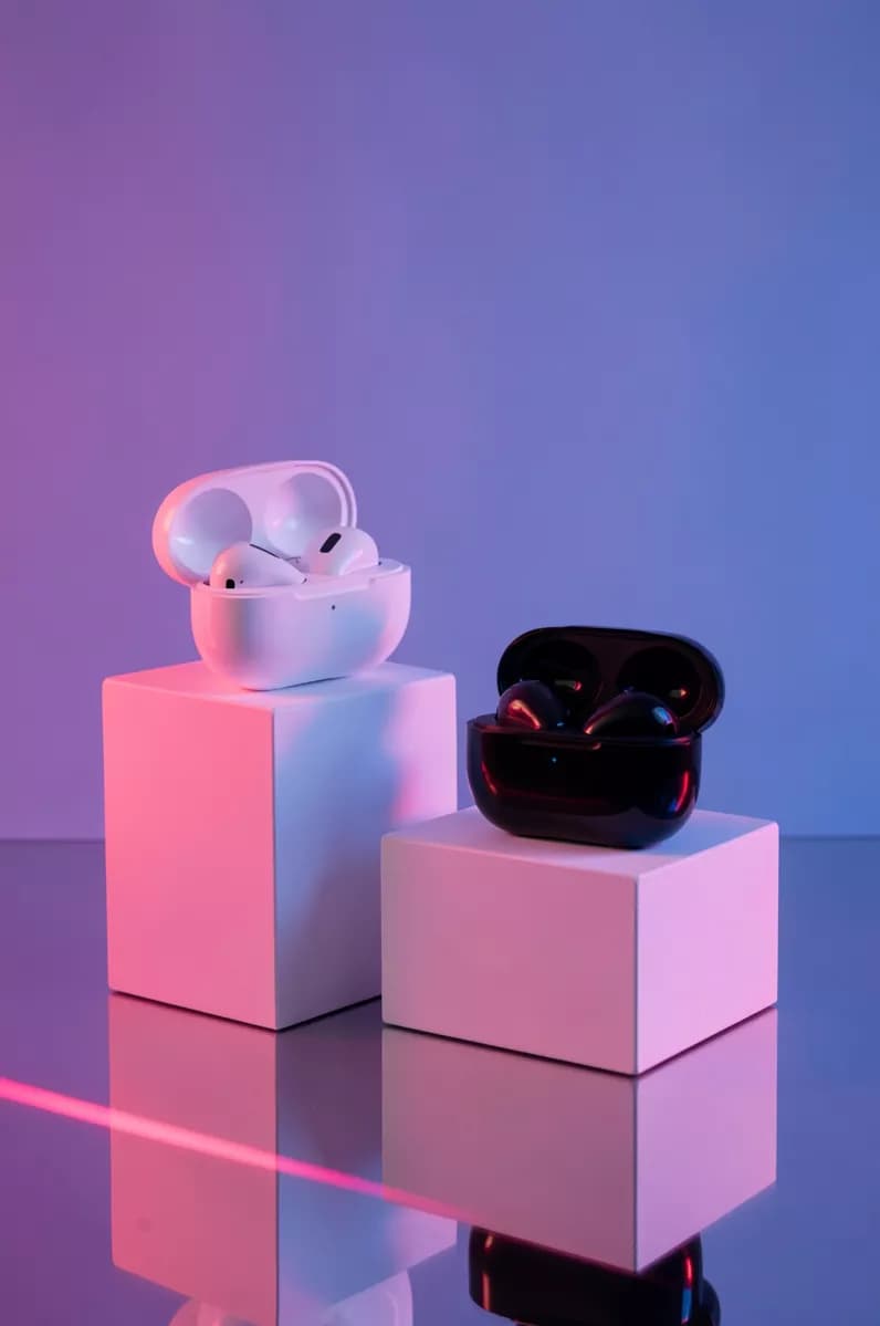 FLUX.2 Klein — Product and e-commerce: Two wireless earbud charging cases displayed on white geometric podiums, both op