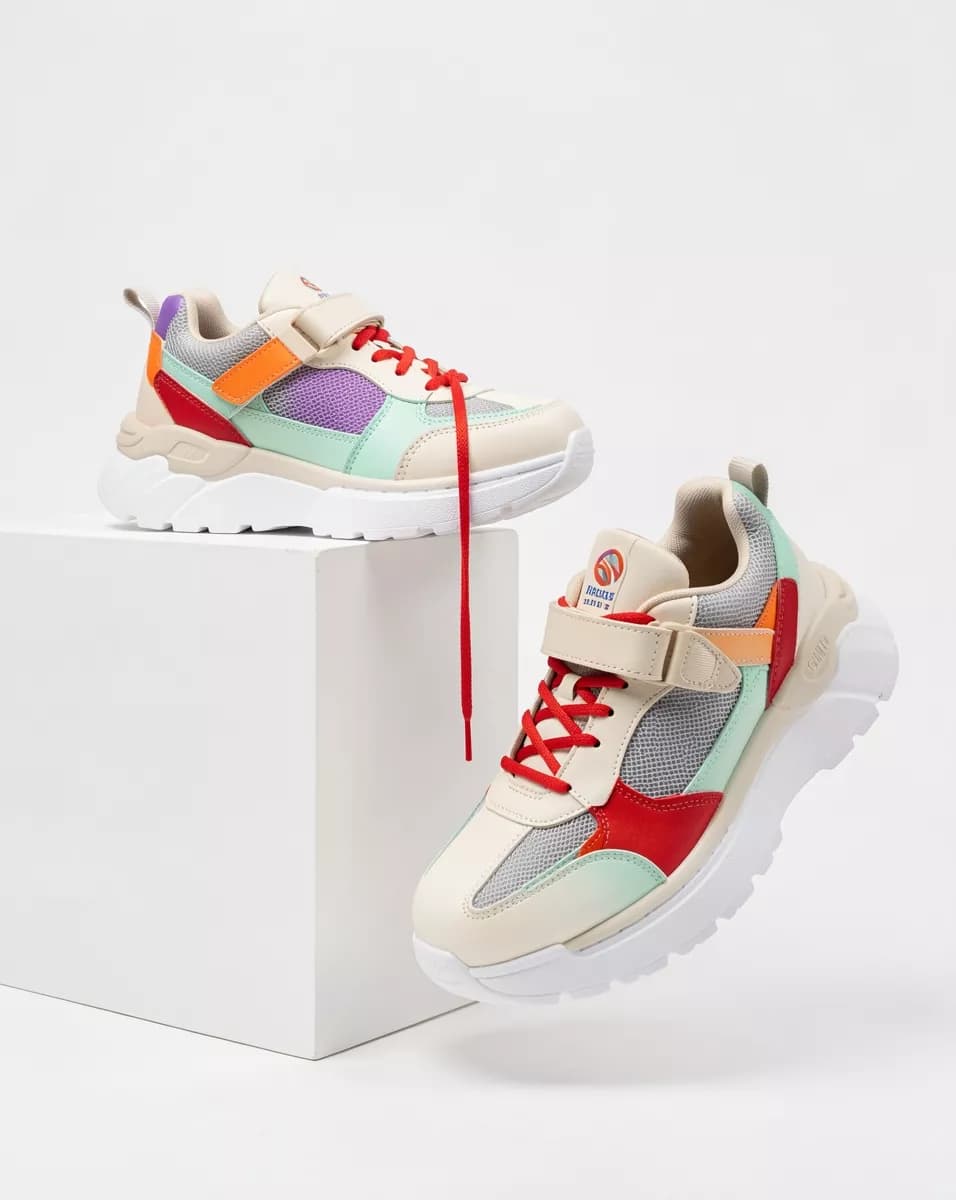 Product and e-commerce: Two chunky sneakers on a white seamless background with a white plinth. One rest