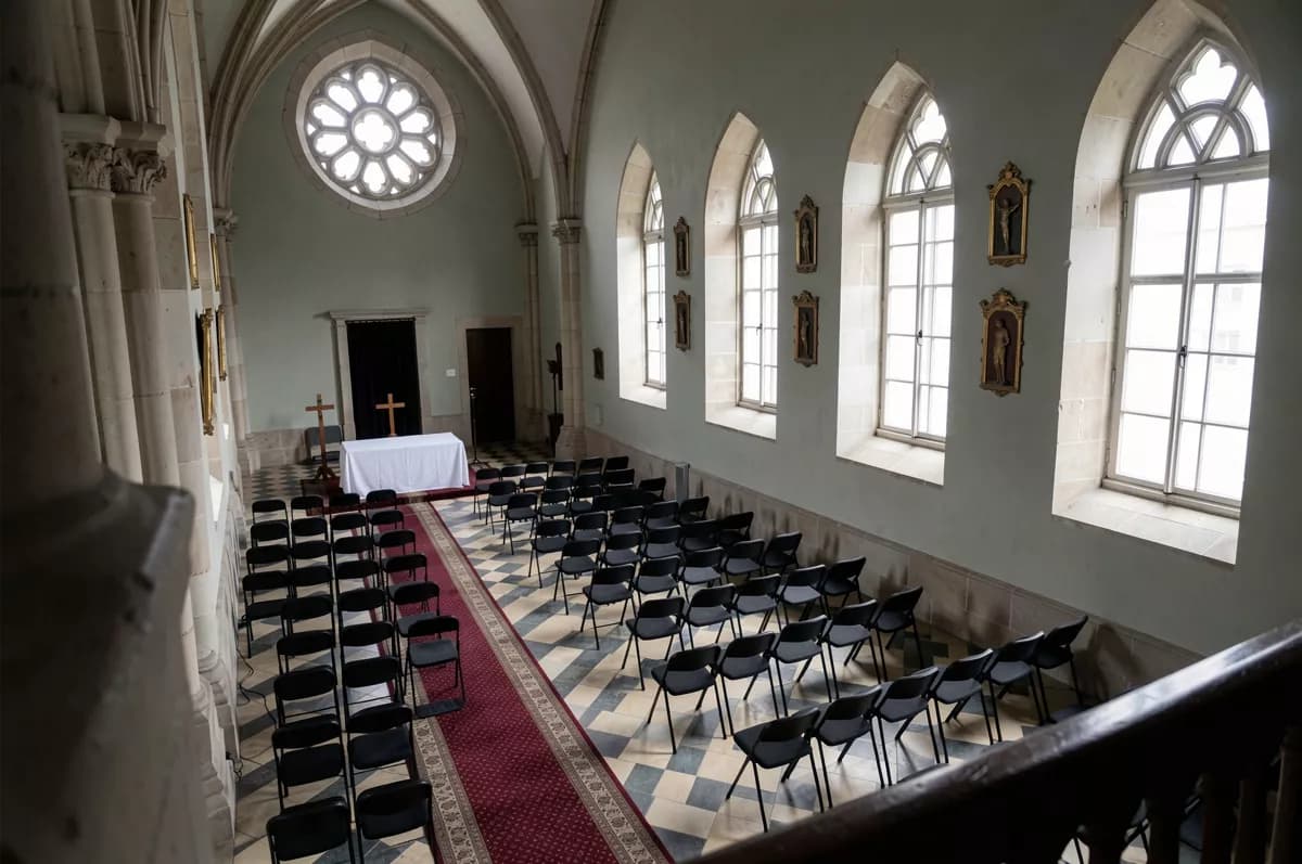 Street and architecture: The interior of a neo-Gothic church seen from a high balcony looking down the na