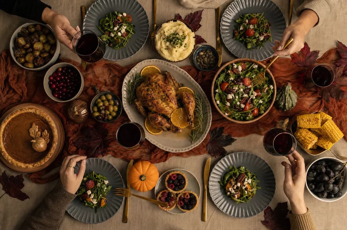 Food and beverage: An autumn holiday dinner table shot straight from above. In the centre a roast c