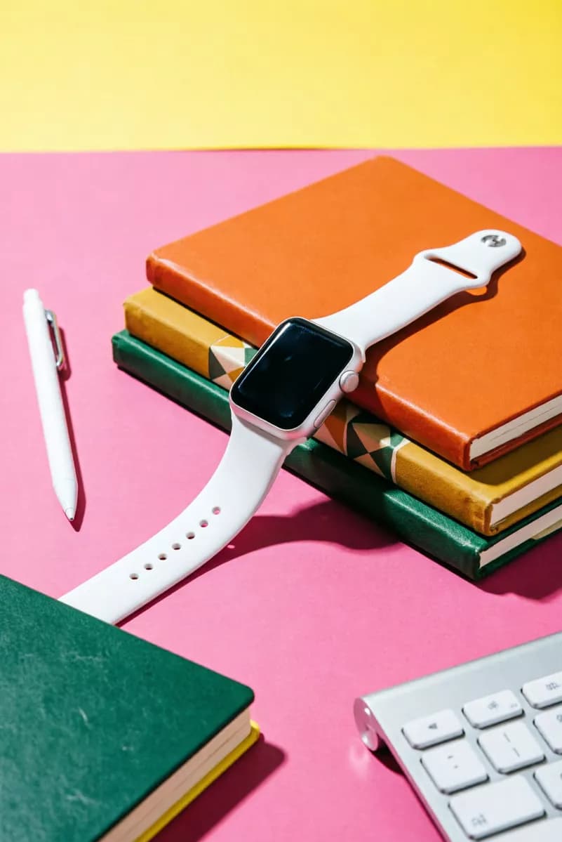 Product and e-commerce: A colour-blocked product still life: a white smartwatch with a square black scre