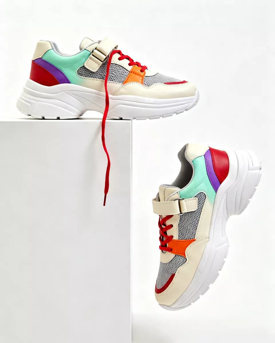Seedream 4.0 — Product and e-commerce: Two chunky sneakers on a white seamless background with a white plinth. One rest